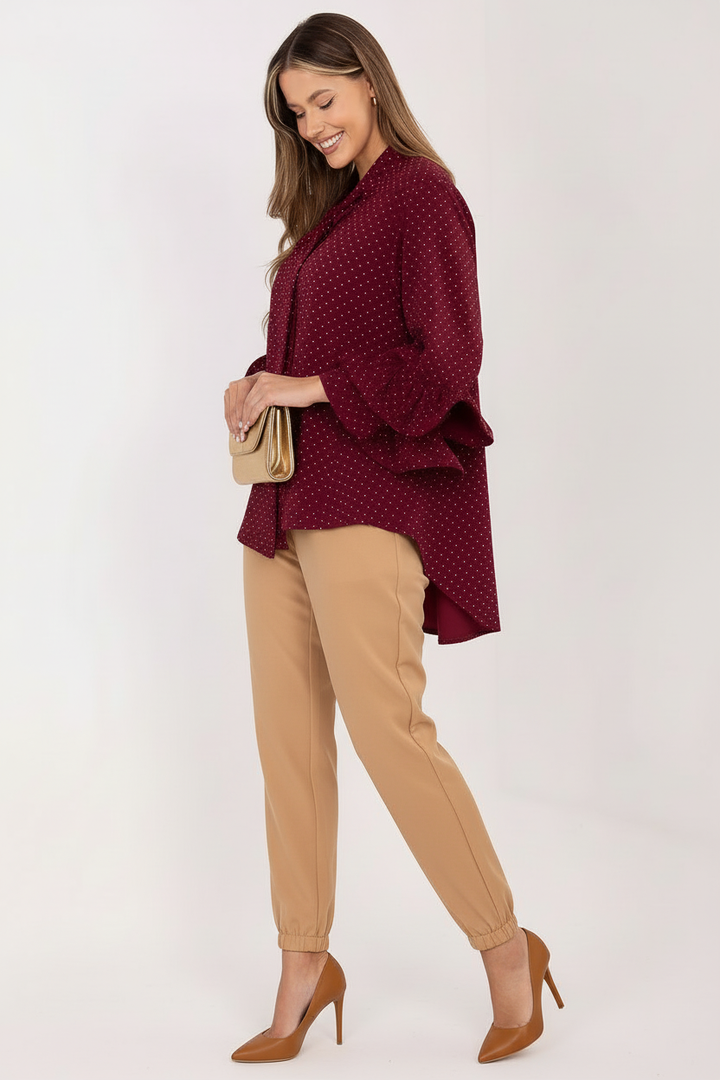 Burgundy jet appliqué shirt with bold beige joggers, beige heels and gold bag